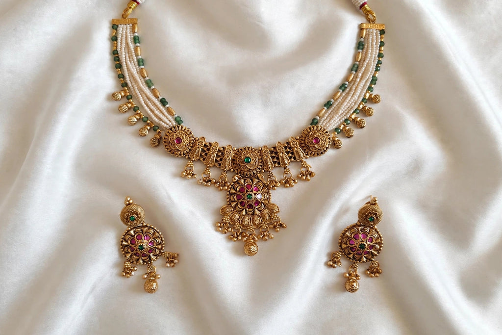 Rajwada – Antique Gold Finish Multi-Strand Pearl Necklace Set with Ruby-Pink Floral Pendant